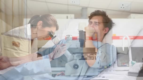 Animation of a man laying in a hospital bed, coughing, coronavirus Covid-19 spreading, over a female doctor looking through microscope in the background. - Felvétel, videó