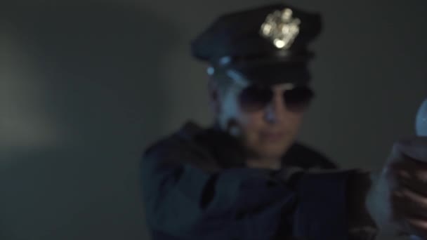 policjant w kombinezonie policyjnym sprawdza temperaturę zdalnie, trzyma termometr na podczerwień, wykrywa temperaturę cieplną u ludzi z zakażonym wirusem korony - Materiał filmowy, wideo
