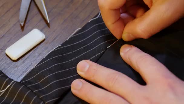 bespoke tailoring artisan tradition : Sewing a  tailored black jacket suit. Close-up shot - Footage, Video