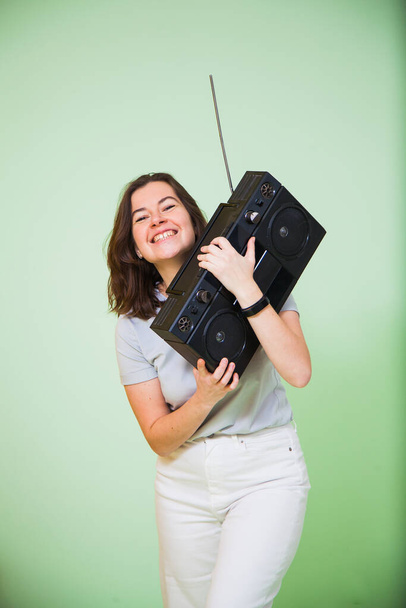 Happy young woman with retro music player. - Photo, Image