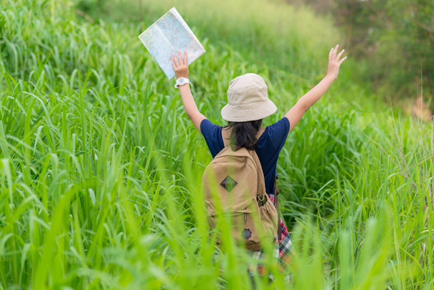 People asia  kid holding maps travel backpacks and walking in the jungle forest for education nature and camping in sunset background,  destination and leisure in holiday. Travel and Family Concep - Foto, imagen