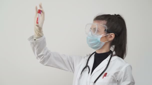 Female scientist, comparing blood samples or serums. Testing patients for coronavirus in laboratory - Metraje, vídeo