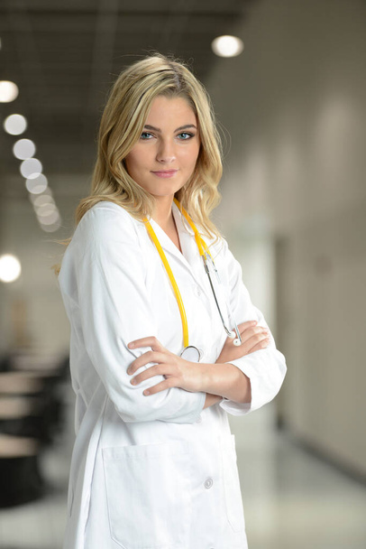 Young Doctor woman at the hospital with her arms crossed - Photo, Image