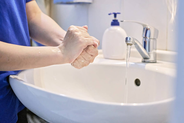 Coronavirus prevention. Personal hygiene to stop spreading coronavirus pandemic. Scrubbing hands 20 seconds and rinsing hands well under running water - Photo, Image