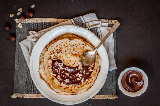 Thin Crepes with Chocolate Spread and Hazelnuts, copy space for your text - 写真・画像