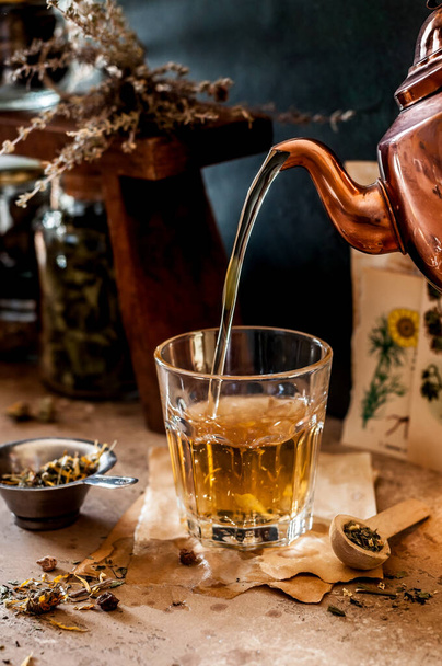 Pouring Herbal Tea into a Glass, Variety of Dried Herb Mixes, copy space for your text - Photo, image