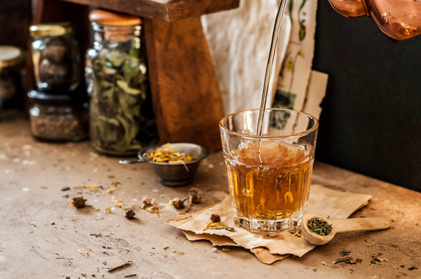 Pouring Herbal Tea into a Glass, Variety of Dried Herb Mixes, copy space for your text - Foto, immagini