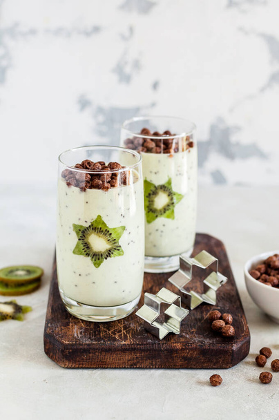Kiwifruit Smoothie Decorated with Star Shaped Kiwi Slices with Cocoa Cereal, copy space for your text - Fotó, kép