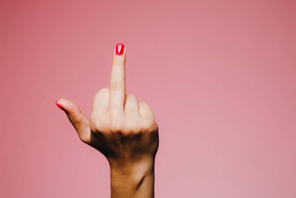Woman's hands with bright manicure isolated on pink background go away sign - Fotoğraf, Görsel