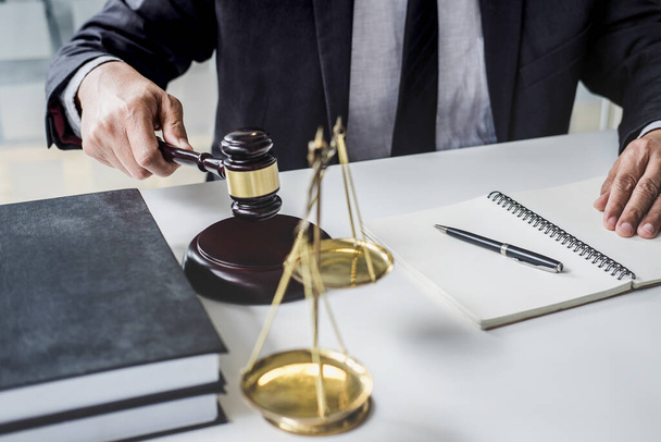 Male lawyer or judge working with contract papers, Law books and wooden gavel on table in courtroom, Justice lawyers at law firm, Law and Legal services concept. - Photo, Image