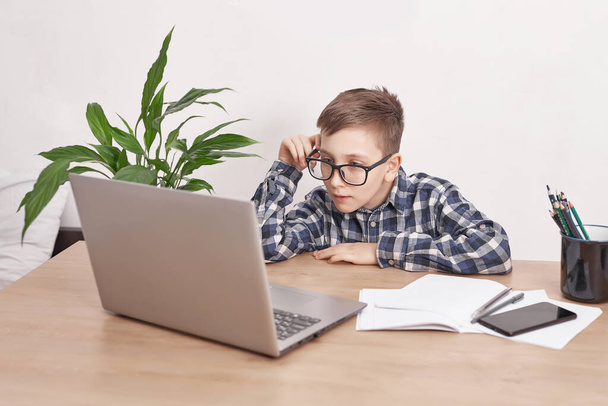 Online lesson at home, social distance during quarantine, self-isolation, online education concept, home schooler. Boy learning language online, using laptop, distance education. Student boy, school. - Zdjęcie, obraz