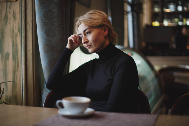 A beautiful Woman Drinks Coffee from a white mug. - Fotoğraf, Görsel