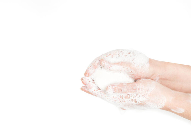 Woman washing hands with a soap bar on a white background - Photo, Image