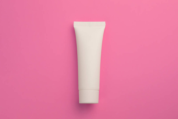 Natural cosmetic in white tube in the middle of pink background - Photo, Image