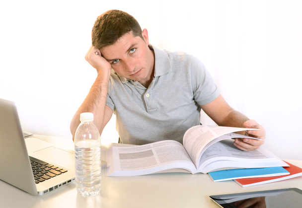Stressed Student with Book and Laptop - Photo, Image