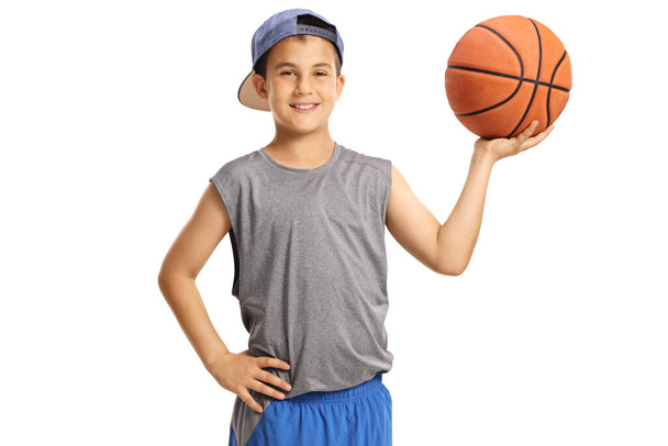 Boy in sportswear holding a basketball isolated on white background - Photo, Image
