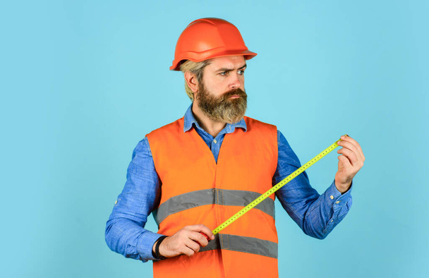 Worker use tape measure. Size concept. Hipster in hard hat. Make measurements apartment renovation. Safety Engineer Measure Acceptable Parameters. Builder with tape measure. Custom made furniture - Foto, immagini