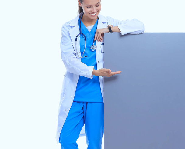 A female doctor with a blank billboard. - Foto, Imagen