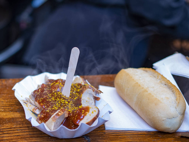 hot bratwurst in sauce, bun, ketchup, street food - Photo, Image