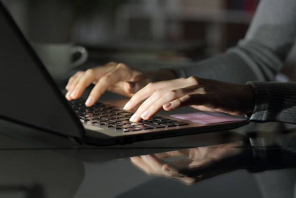 Крупним планом жінка набирає руки на ноутбук вночі на столі вдома
 - Фото, зображення