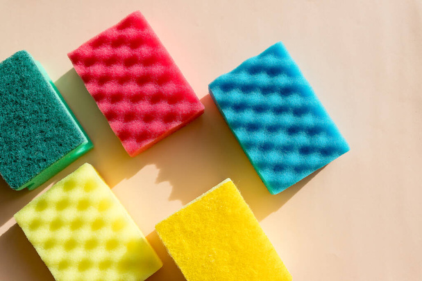 Multi-colored foam rubber sponge for cleaning and washing dishes on a white background. top view, pattern. flat lay.Sponges for washing and cleaning. Detergents for cleaning or disinfecting the room. - Photo, Image