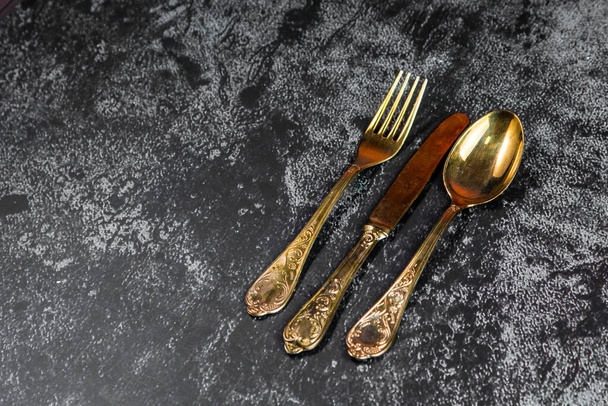 Vintage golden dinner set on a grundge blue background - Zdjęcie, obraz