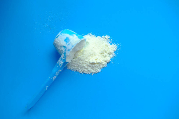 Milk powder for baby in measuring spoon. - Photo, Image
