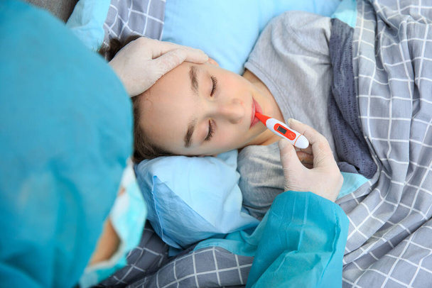 Mother and child in home quarantine , quarantine. health concept. Corona Virus. Infected boy in quarantine lying in bed with mather , coronavirus concept - 写真・画像
