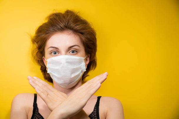Close-up Portrait of a young woman in a medical mask protecting against the coronavirus pandemic, face protection against the spread of the covid-19 virus, epidemic concept - Photo, Image