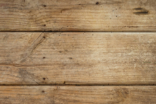 Background of weathered wooden planks with nails and streaks. Texture of old and big wooden boards of light brown colors. - Photo, Image