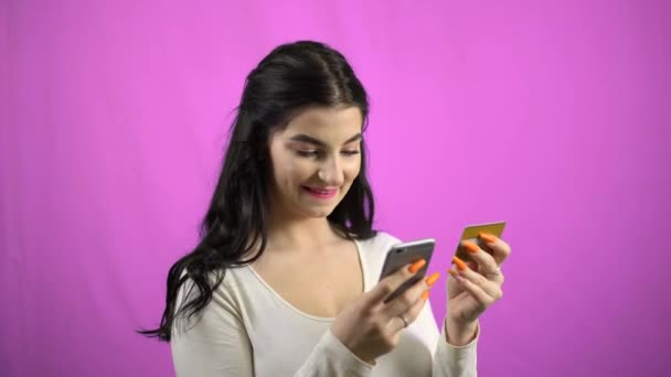 Young happy woman making card payment through mobile phone online buying - Filmagem, Vídeo