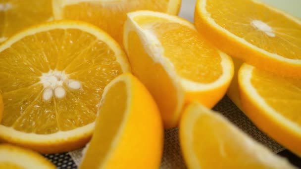 Řezané masové pomeranče se otáčejí na stole - Záběry, video