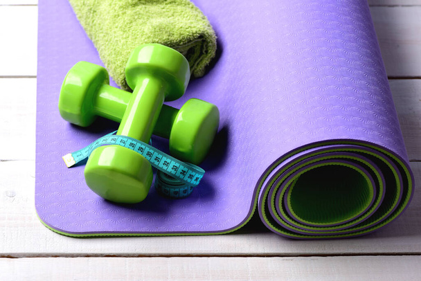 Shaping and fitness equipment. Dumbbells made of green plastic - Фото, изображение