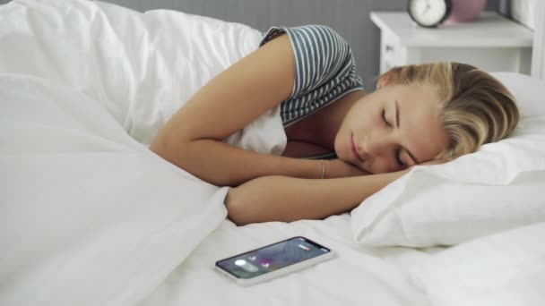 Young beautiful woman waked up by phone call in the morning - Footage, Video