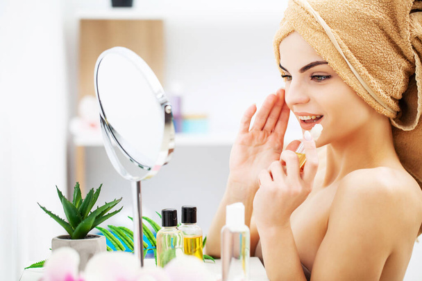 Mujer bonita aplicando maquillaje en la cara en casa
 - Foto, imagen