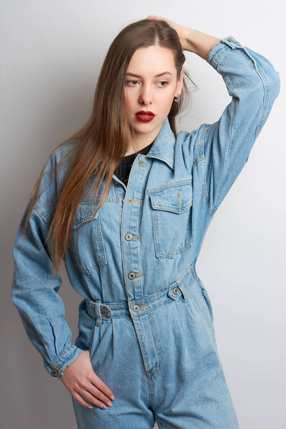 beautiful girl with red lipstick in a denim suit on a white background.girl's emotions - Fotografie, Obrázek
