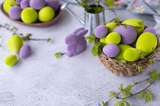 easter green and purple eggs with rabbit on a light surface - Fotografie, Obrázek