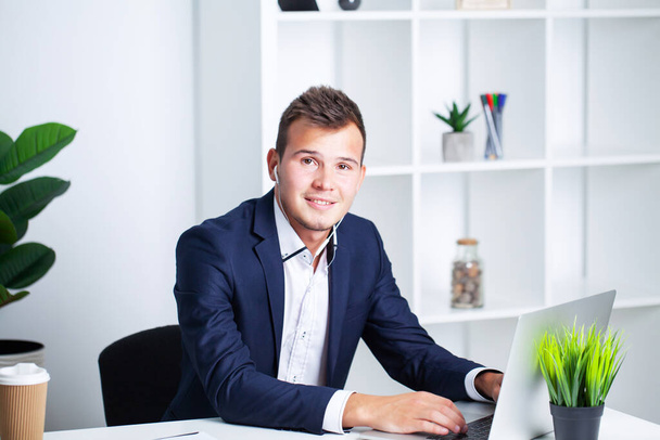Solid businessman in a jacket works in office of company. - Valokuva, kuva