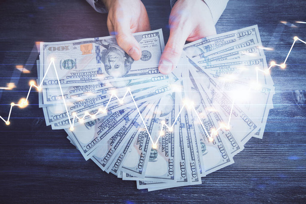 Multi exposure of financial graph drawing hologram and USA dollars bills and man hands. Analysis concept. - Φωτογραφία, εικόνα