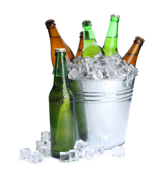 Metal bucket with bottles of beer and ice cubes isolated on white - Valokuva, kuva