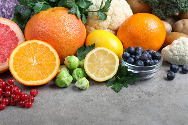 Different products rich in vitamin C on light grey table - 写真・画像