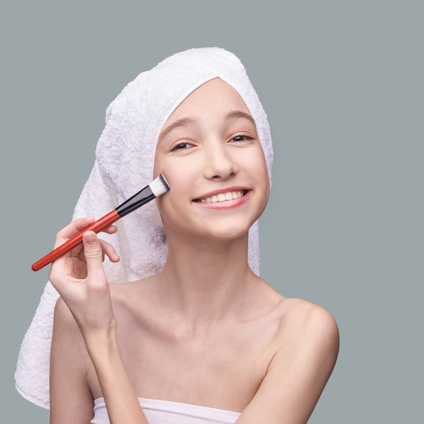 Girl with cosmetic brush. Beauty woman portrait. Pilling concept - Photo, image