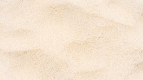fijn strand zand textuur in de zomer zon als achtergrond - Foto, afbeelding