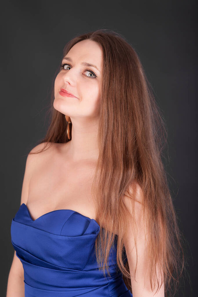 girl with long hair in a blue dress - Fotoğraf, Görsel