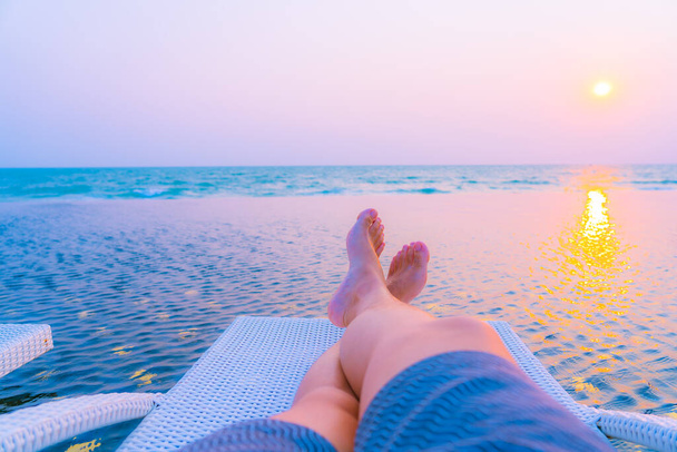 Selektiver Fokus auf Bein rund um Freibad im Hotelresort bei Sonnenuntergang oder Sonnenaufgang für Freizeit und Urlaub - Foto, Bild