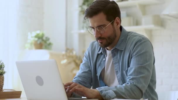 Concentrated young man freelancer working remotely at home. - Filmmaterial, Video