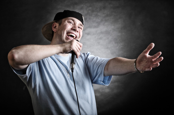Rap singer man with microphone cool hand gesture - Fotó, kép