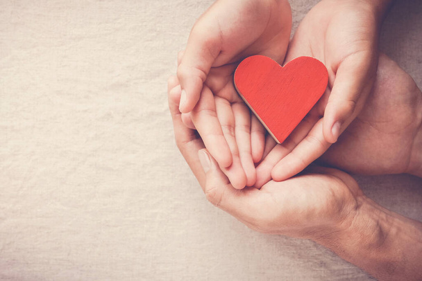 hands holding red heart, heart health, donation, happy volunteer charity, CSR social responsibility,world heart day, world health day,world mental health day,foster home, wellbeing, hope concept - Фото, изображение