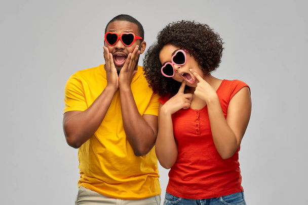 happy african couple in heart shaped sunglasses - Foto, imagen