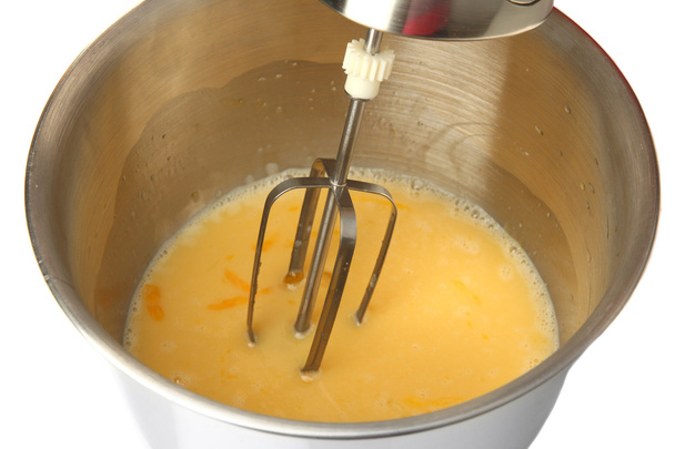 Cooking, whipping eggs with electric whisk in bowl, close up - Fotografie, Obrázek